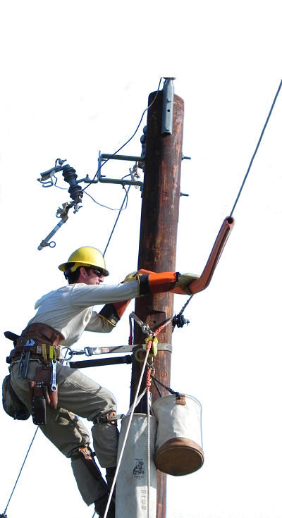 Lineworker on top of pole